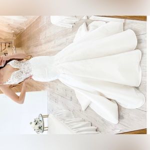 Brand NEW wedding dress. Never worn. No alterations. Original garment bag & tags